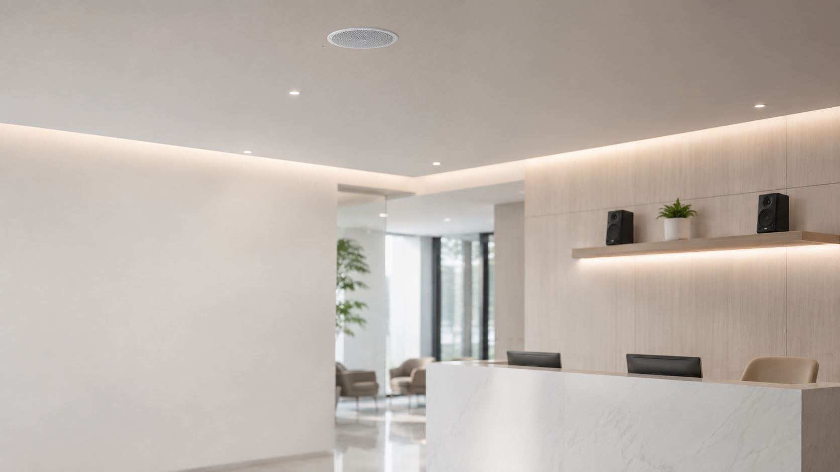 Ceiling speaker and shelf speakers installed in a bright office reception area